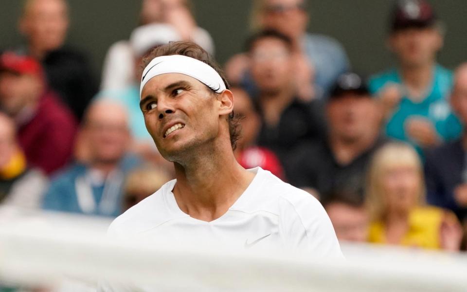 Spain's Rafael Nadal reacts after losing a point as he plays Argentina's Francisco Cerundolo in a first round men's singles match on day two of the Wimbledon tennis championships in London, Tuesday, June 28, 2022. - AP