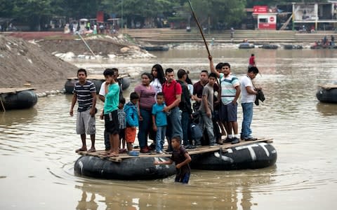 Migrants crossing the Suchiate river, the border between Guatemala and Mexico - Credit: Encarni Pindado&nbsp;/The Telegraph
