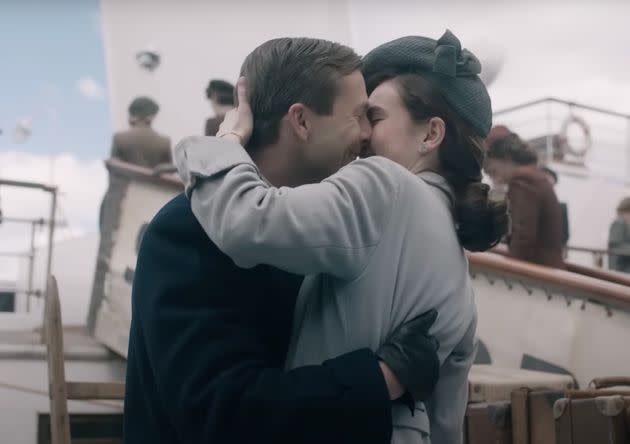 Glen Powell and Lily James share a kiss in The Guernsey Literary And Potato Peel Pie Society