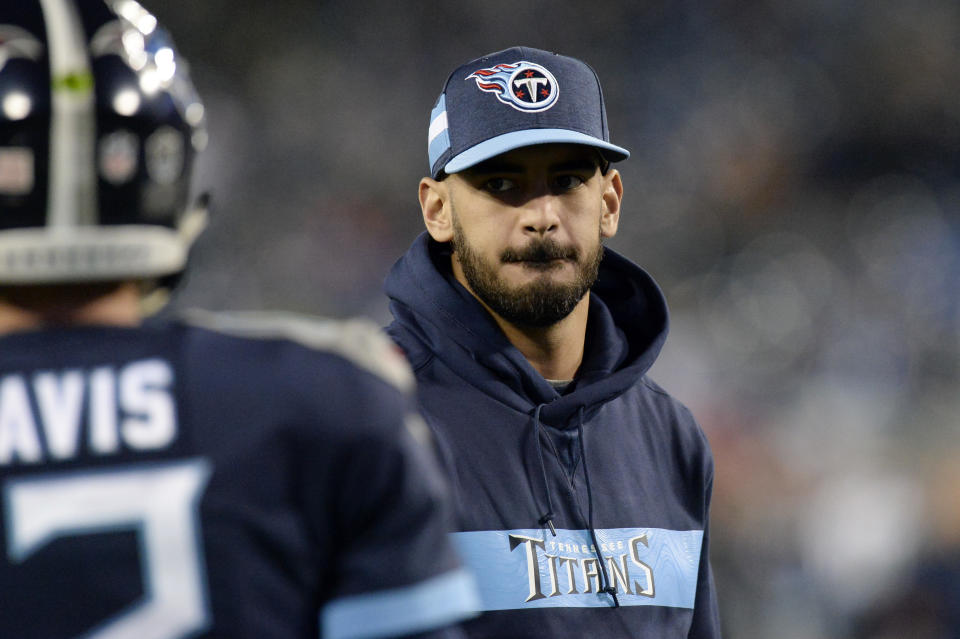 Injured Tennessee Titans quarterback Marcus Mariota watches as teammates warm up before an NFL football game against the Indianapolis Colts Sunday, Dec. 30, 2018, in Nashville, Tenn. (AP Photo/Mark Zaleski)