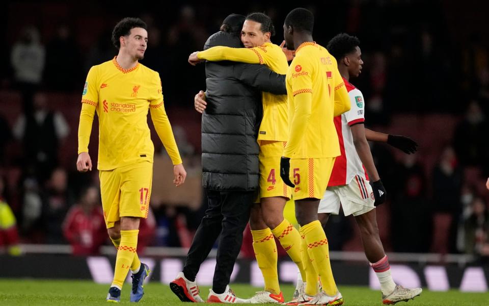 Liverpool's manager Jurgen Klopp, center, hugs Virgil van Dijk after the English League Cup semifinal - AP