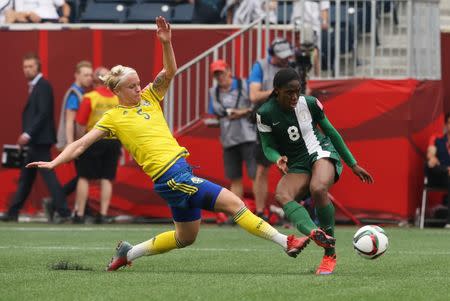 Nigeria forward Asisat Oshoala (8) scores as Sweden defender Nilla Fischer (5) pursues in a Group D soccer match in the 2015 women's World Cup at Winnipeg Stadium. Mandatory Credit: Bruce Fedyck-USA TODAY Sports