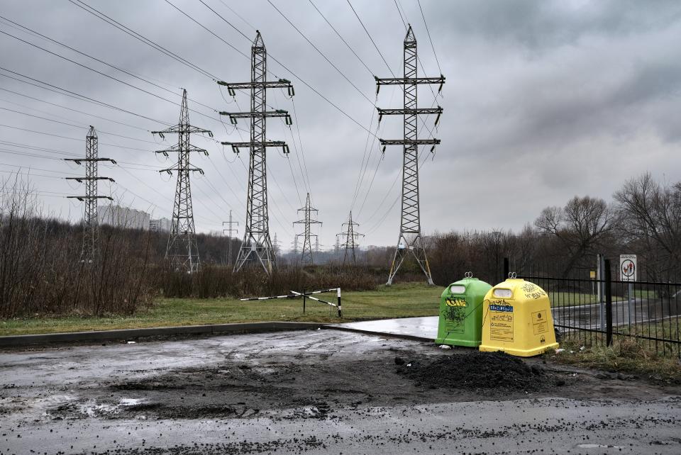In this photo taken on Sunday, Nov. 3, 2019, waste collection containers and high voltage lines are seen in Liublino, a working class suburb in Moscow, Russia. Moscow’s suburbs are the focus of a major international art exhibition that has just opened in the Russian capital. The exhibit uses contemporary art to explore the many hidden facets of life beyond the Russian capital’s nucleus. Austrian cultural attache says the ‘real’ Moscow where most of the city’s 12.6 million people live, is outside the center. (AP Photo/Alexander Zemlianichenko)