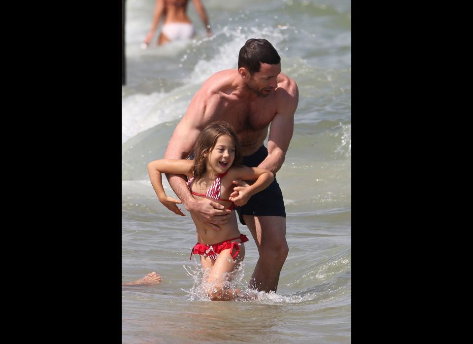Hugh Jackman takes his daughter Ava for a dip while he and his family vacation in St. Tropez, France.