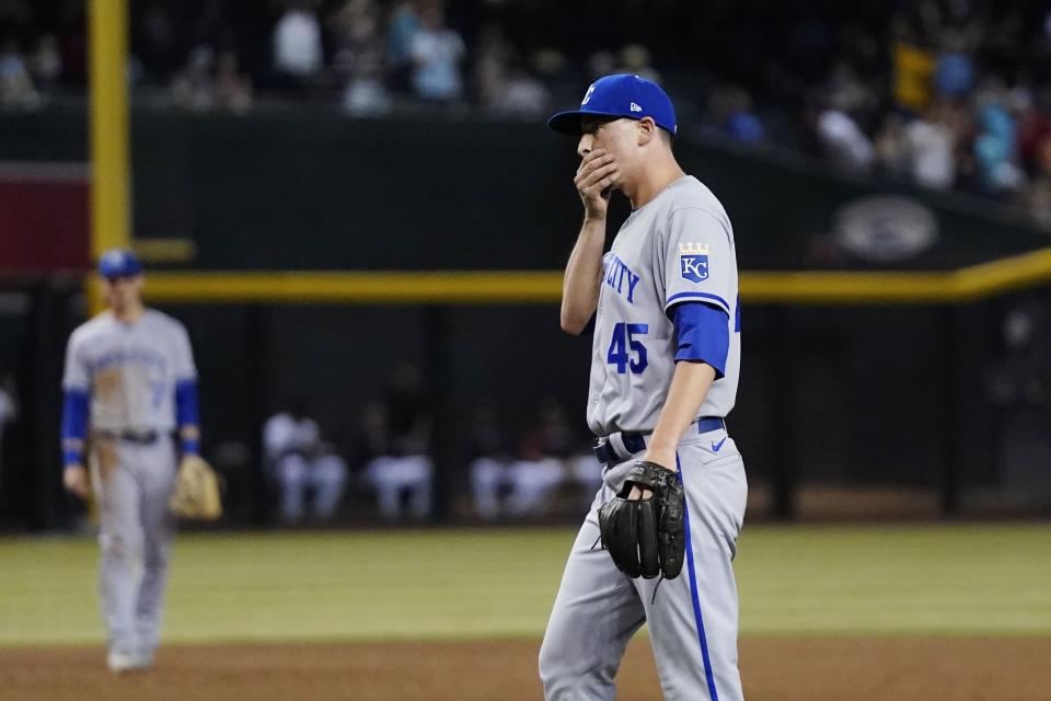 Kansas City Royals pitcher Taylor Clarke pauses on the field after giving up a home run to Arizona Diamondbacks' Pavin Smith during the sixth inning of a baseball game Tuesday, May 24, 2022, in Phoenix. (AP Photo/Ross D. Franklin)