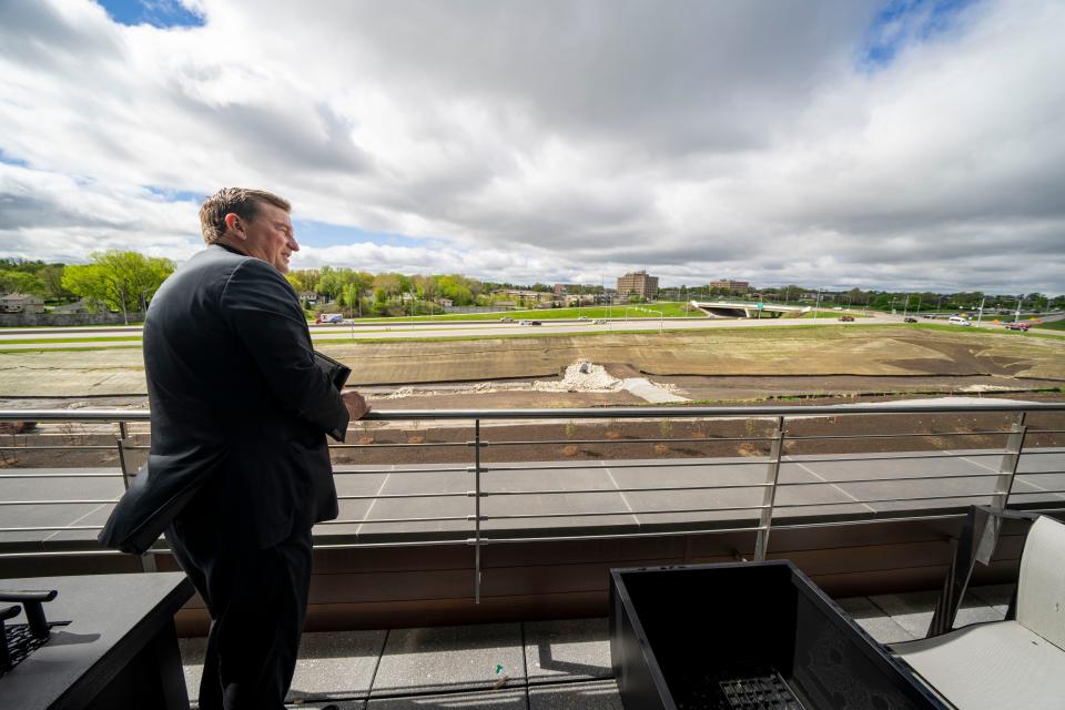 David Nelson, president and CEO of West Bank, looks out from the fourth story patio of the bankÕs new headquarters in West Des Moines, Monday, April 29, 2024.