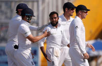 Cricket - India v England - Third Test cricket match - Punjab Cricket Association Stadium, Mohali, India - 28/11/16. England's Adil Rashid (C) celebrates with his teammates after dismissing India's Ravindra Jadeja. REUTERS/Adnan Abidi