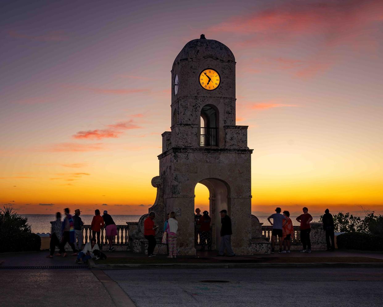 Locals gather for the traditional sunrise photo at the Palm Beach Clock Tower to help ring in the New Year on Jan. 1.