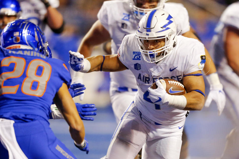 Air Force fullback Omar Fattah (44) runs with the ball as Boise State cornerback Kekaula Kaniho (28) closes in for a tackle attempt during the second half of an NCAA college football game Saturday, Oct. 16, 2021, in Boise, Idaho. Air Force won 24-17. (AP Photo/Steve Conner)