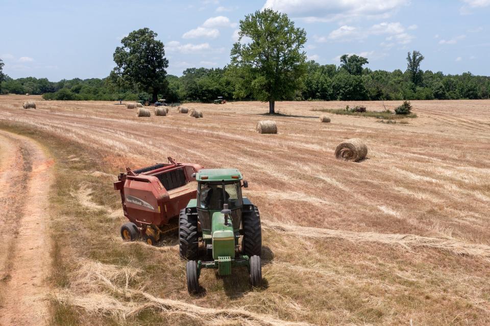 John Boyd runs a hay baler at his farm in Boydton, Va., on May 27. Two generations out of slavery, Black farmers had amassed more than 16 million acres of land by 1910 and made up about 14% of farmers. The fruit of their labors fed much of America. In 2021, they have fewer than 4.7 million acres.