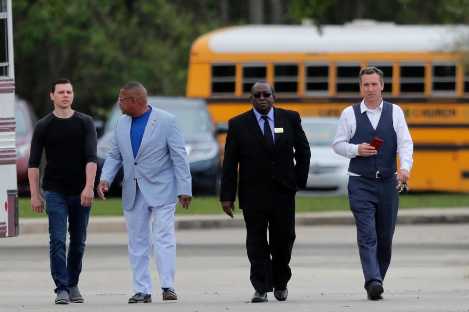 Pastor Tony Spell, right, walks with others after services at the Life Tabernacle Church in Central, La., Sunday, March 29.