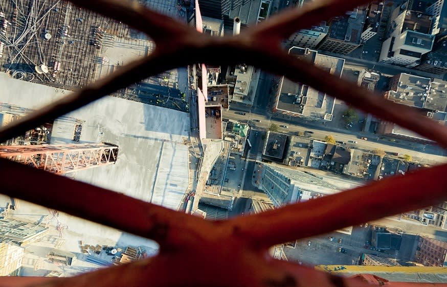 Peering through a metal grate to the street below <b>Photo - Tom Ryaboi</b>