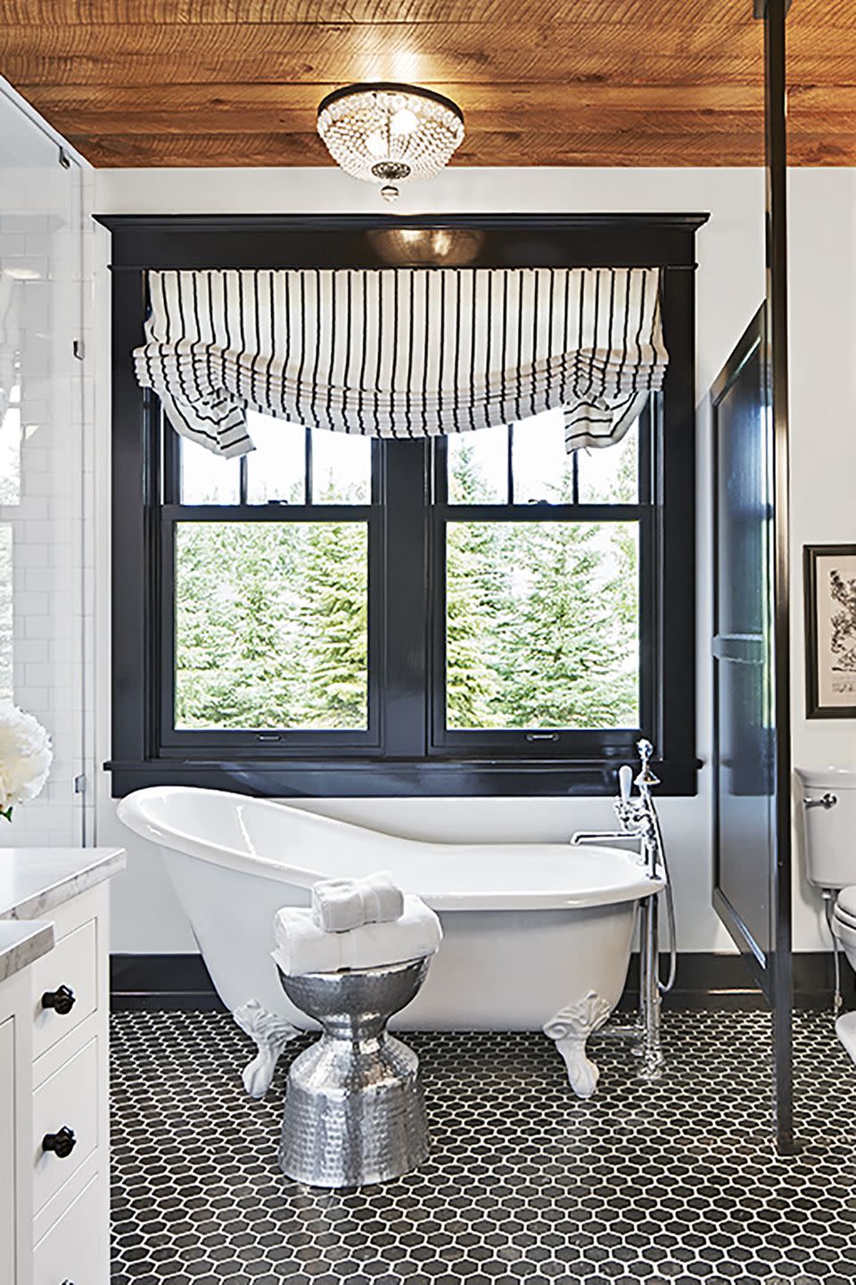 black and white bathroom with black trim and black hexagonal tile floor
