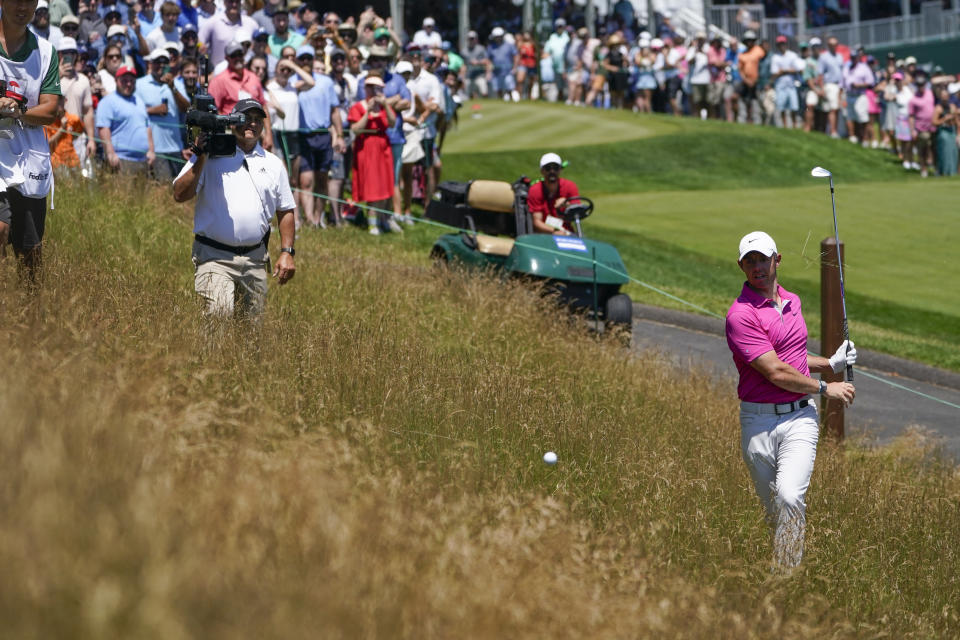 Rory McIlroy, of Northern Ireland, hits out of the rough on the second hole during the third round of the Travelers Championship golf tournament at TPC River Highlands, Saturday, June 25, 2022, in Cromwell, Conn. (AP Photo/Seth Wenig)