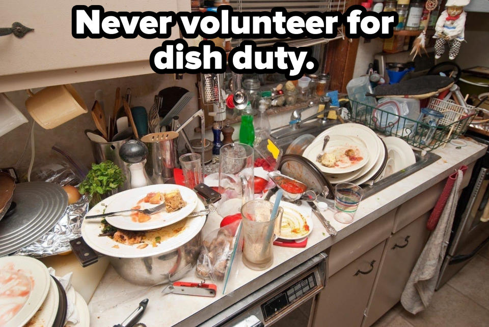 A kitchen with dirty dishes overflowing in the sink and the countertop, with the caption "Never volunteer for dish duty"