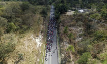 Migrants walk along a highway in hopes of reaching the distant United States, near Agua Caliente, Guatemala, Thursday, Jan. 16, 2020, on the border with Honduras. Hundreds of Honduran migrants started walking and hitching rides Wednesday from the city of San Pedro Sula, in a bid to form the kind of migrant caravan that reached the U.S. border in 2018. (AP Photo/Santiago Billy)