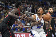 Orlando Magic's Markelle Fultz (20) looks for a shot against Toronto Raptors' Pascal Siakam, left, during the second half of an NBA basketball game Friday, Dec. 9, 2022, in Orlando, Fla. (AP Photo/John Raoux)