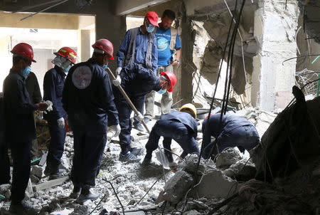 Rescue workers search for bodies still trapped under mounds of debris in Raqqa, Syria April 9, 2018. REUTERS/Aboud Hamam