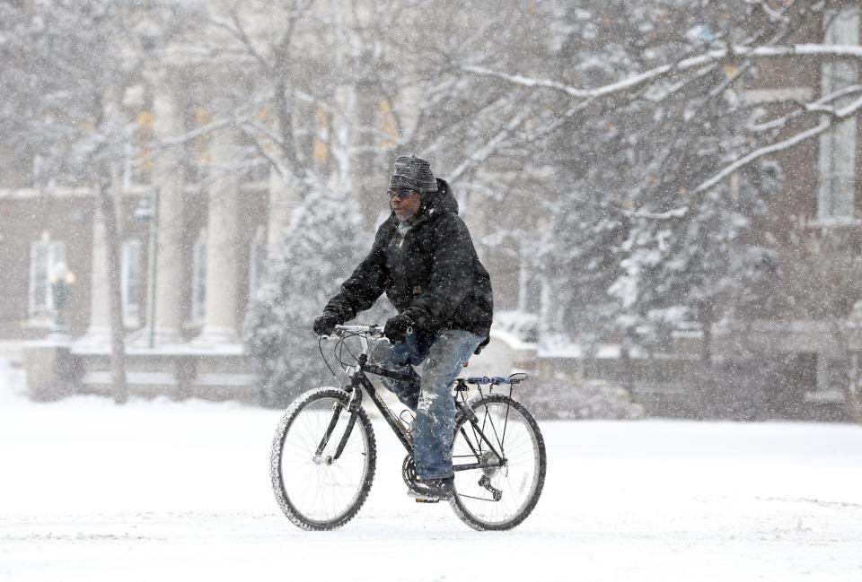 A man bikes through the snow on Thursday, Jan. 2, 2014, in Albany, N.Y. Up to 5 inches of snow have fallen in eastern New York early Thursday, but the National Weather Service said some areas from Buffalo to Albany could get up to 12 inches by the time the storm subsides on Friday. (AP Photo/Mike Groll)