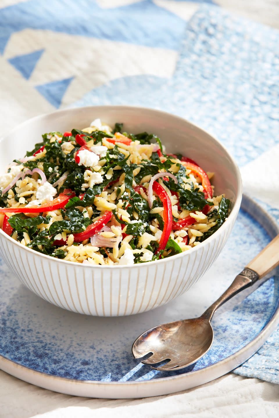 orzo pasta salad in a bowl with a spoon