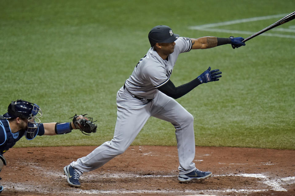 New York Yankees' Aaron Hicks follows he flight of his run-scoring sacrifice fly off Tampa Bay Rays relief pitcher Jeffrey Springs during the seventh inning of a baseball game Wednesday, May 12, 2021, in St. Petersburg, Fla. Yankees' Aaron Judge scored. (AP Photo/Chris O'Meara)