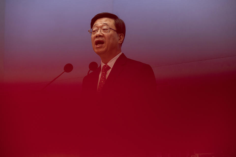 FILE - Hong Kong Chief Executive John Lee speaks during a news conference in Hong Kong, March 21, 2023. Lee said Tuesday, July 4, that eight pro-democracy activists who now live in the United States, Britain, Canada and Australia will be pursued for life for alleged national security offenses, dismissing criticism that the move to have them arrested was a dangerous precedent. (AP Photo/Louise Delmotte, File)