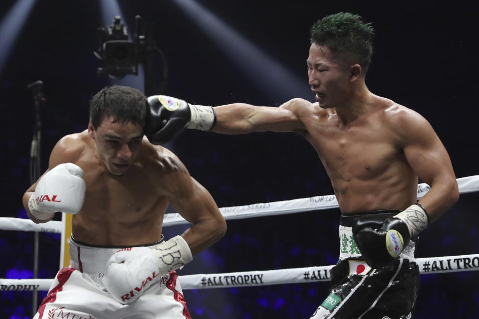 Japan's Takuma Inoue, right, sends a right to France's Nordine Oubaali in the 12th round of their WBC world bantamweight title match in Saitama, Japan, Thursday, Nov. 7, 2019. Oubaali defeated Inoue by a unanimous decision. (AP Photo/Toru Takahashi)