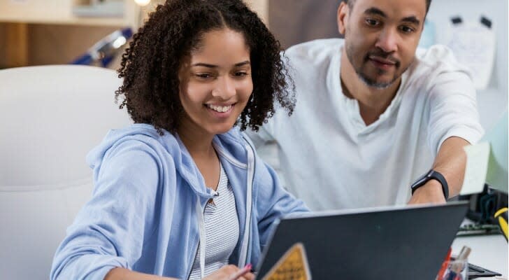 Father and daughter calculate their student loan interest deduction