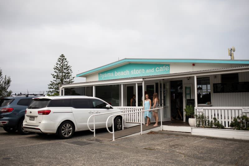Customers stand at the entrance of the Hyams Beach Store and Cafe, in Hyams Beach