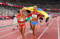 <p>Bronze medallist Ana Peleteiro of Spain and gold medallist Yulimar Rojas of Venezuela soak in their wins following the women's triple jump final at the Olympic Stadium on August 1.</p>