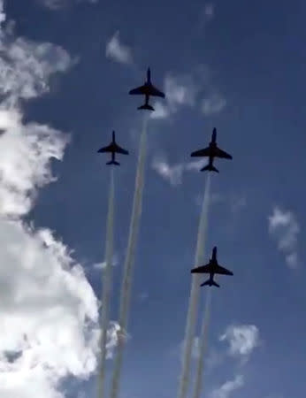 The Royal Air Force Aerobatic Team, known as the Red Arrows, fly over Scampton, Lincolnshire, Britain March 20, 2018 in this still image obtained from social media video. Twitter/ @LAZY_CYCLIST_ via REUTERS ATTENTION EDITORS - THIS IMAGE WAS PROVIDED BY A THIRD PARTY. NO RESALES. NO ARCHIVES. MANDATORY CREDIT: TWITTER / @LAZY_CYCLIST_