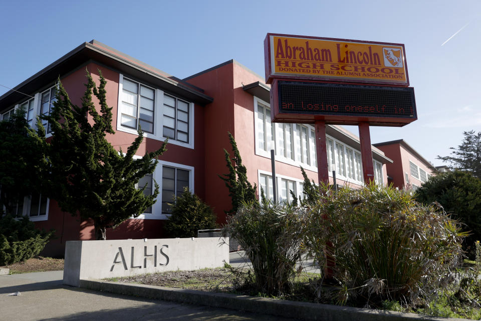 A sign in front of a school reads: Abraham Lincoln High School