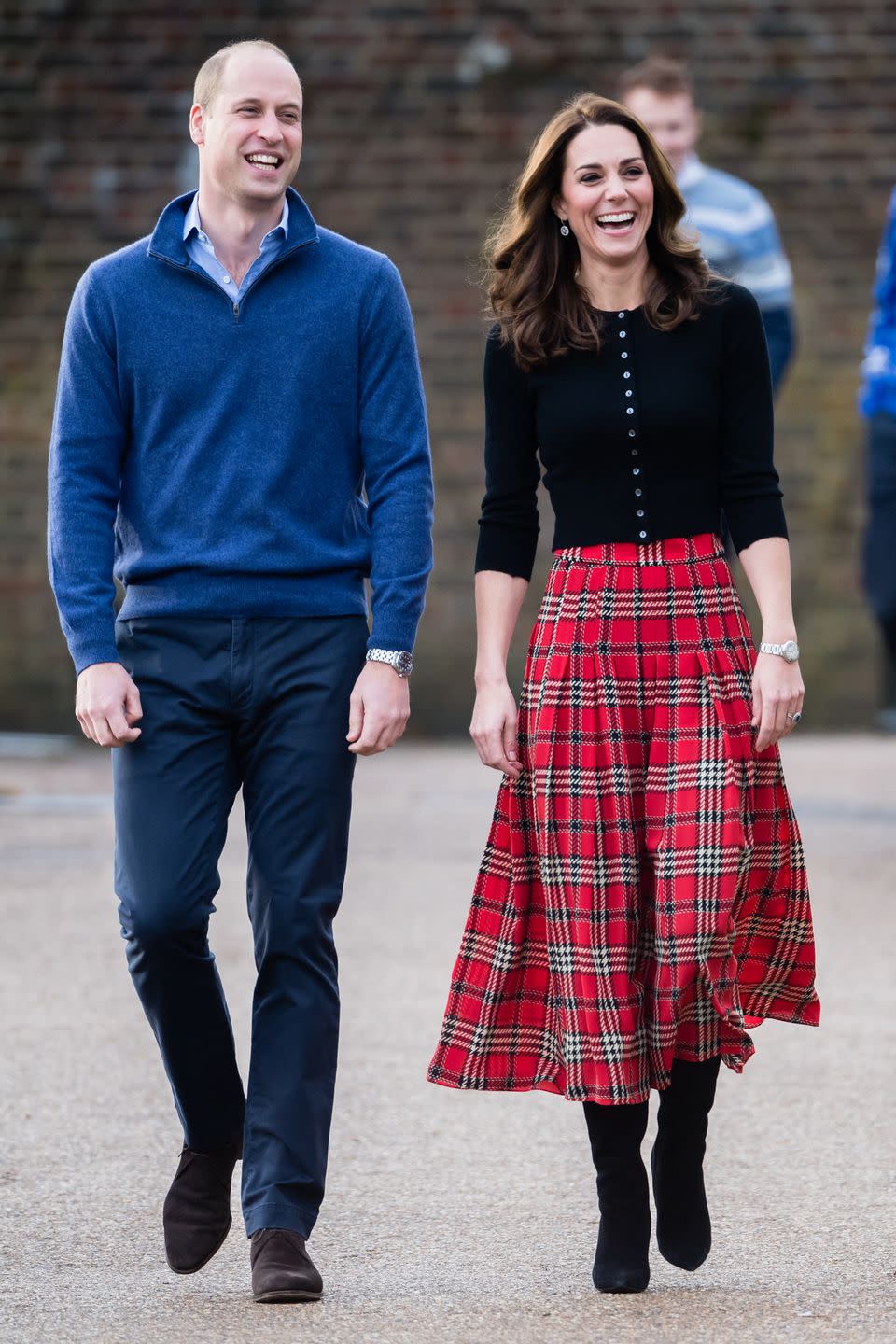 <p>Will and Kate are all smiles as they arrive at a Christmas party for military families in London. The Duchess looked festive in a plaid skirt by Emilia Wickstead with a black sweater by Brora.</p>