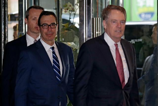 U.S. Treasury Secretary Steven Mnuchin, left, and his Trade Representative Robert Lighthizer arrive at a hotel in Beijing, Thursday, March 28, 2019. Mnuchin and his Trade Representative Robert Lighthizer arrive to China's capital to hold a new round of high-level trade talks with China on March 28-29, start with a working dinner. (AP Photo/Andy Wong)