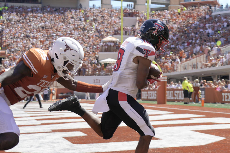 Texas Tech wide receiver Myles Price (18) catches a touchdown pass against Texas defensive back B.J. Foster (25) during the first half of an NCAA college football game on Saturday, Sept. 25, 2021, in Austin, Texas. (AP Photo/Chuck Burton)