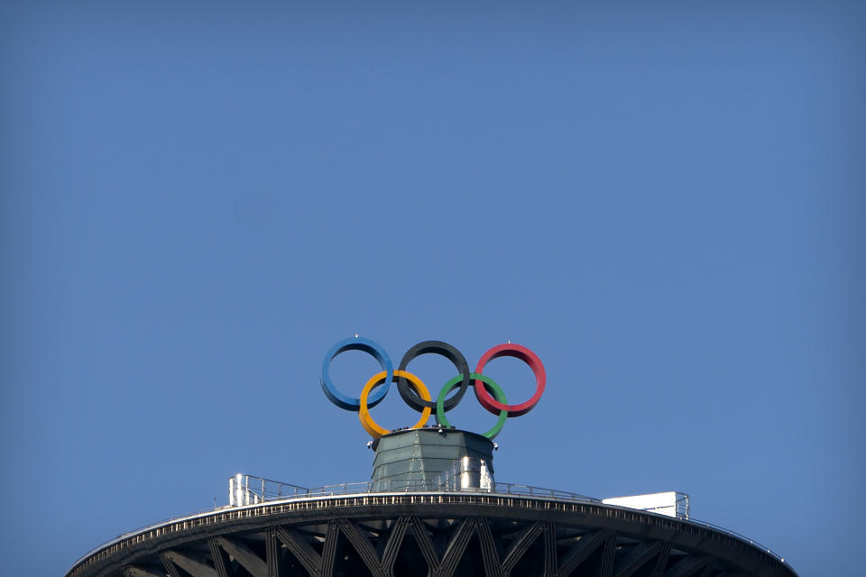 The Olympic rings are visible atop the Olympic Tower in Beijing, Tuesday, Feb. 2, 2021. A small core of international lawyers and activists are prodding leading Olympic sponsors to acknowledge China's widely reported human-rights abuses against Muslim Uyghurs, Tibetans and other minorities. (AP Photo/Mark Schiefelbein)