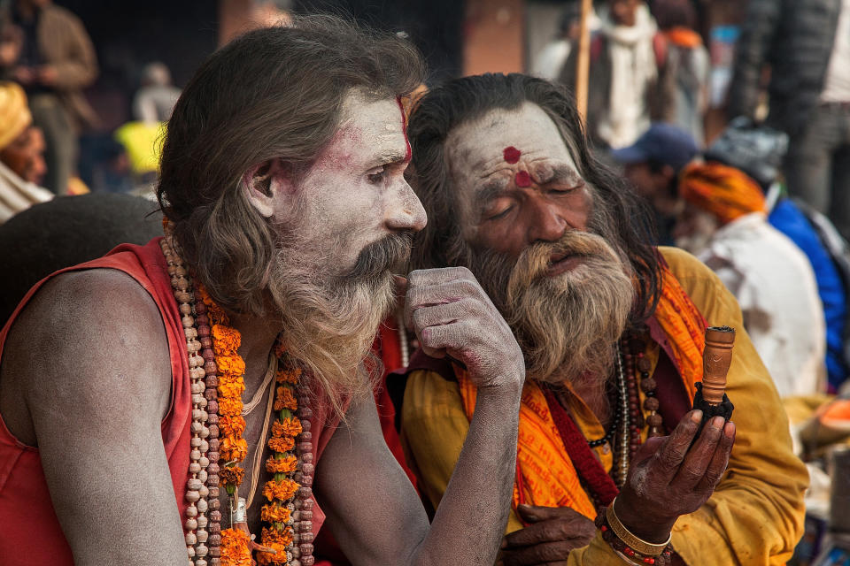 KATHMANDU, NEPAL - FEBRUARY 17:  A Shadu, or holy man, passes a chillum filled with cannabis to another holy man inside Pashupatinath temple during the celebration of the Maha Shivaratri festival on February 17, 2015 in Kathmandu, Nepal. 