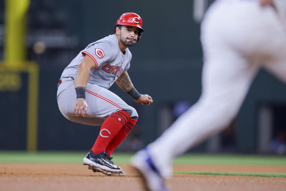 Cincinnati Reds' Christian Encarnacion-Strand stops between second and third base on a ground ball by Tyler Stephenson during the fourth inning of a baseball game against the Texas Rangers in Arlington, Texas, Saturday, April 27, 2024. (AP Photo/Gareth Patterson)