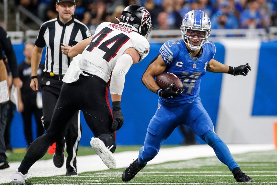 Detroit Lions wide receiver Amon-Ra St. Brown (14) runs against Atlanta Falcons linebacker Troy Andersen (44) during the second half at Ford Field in Detroit on Sunday, Sept. 24, 2023.