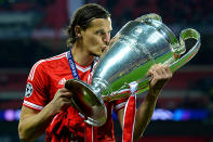 Daniel Van Buyten of Bayern Muenchen holds the trophy after winning the UEFA Champions League final.