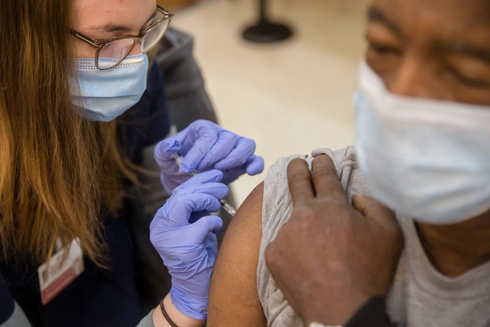 UGA pharmacy student Emily Anne Plauche administers the COVID-19 vaccine to Willie Thompson, during a St. Joseph’s/ Candler clinic for patients age 65 and older.