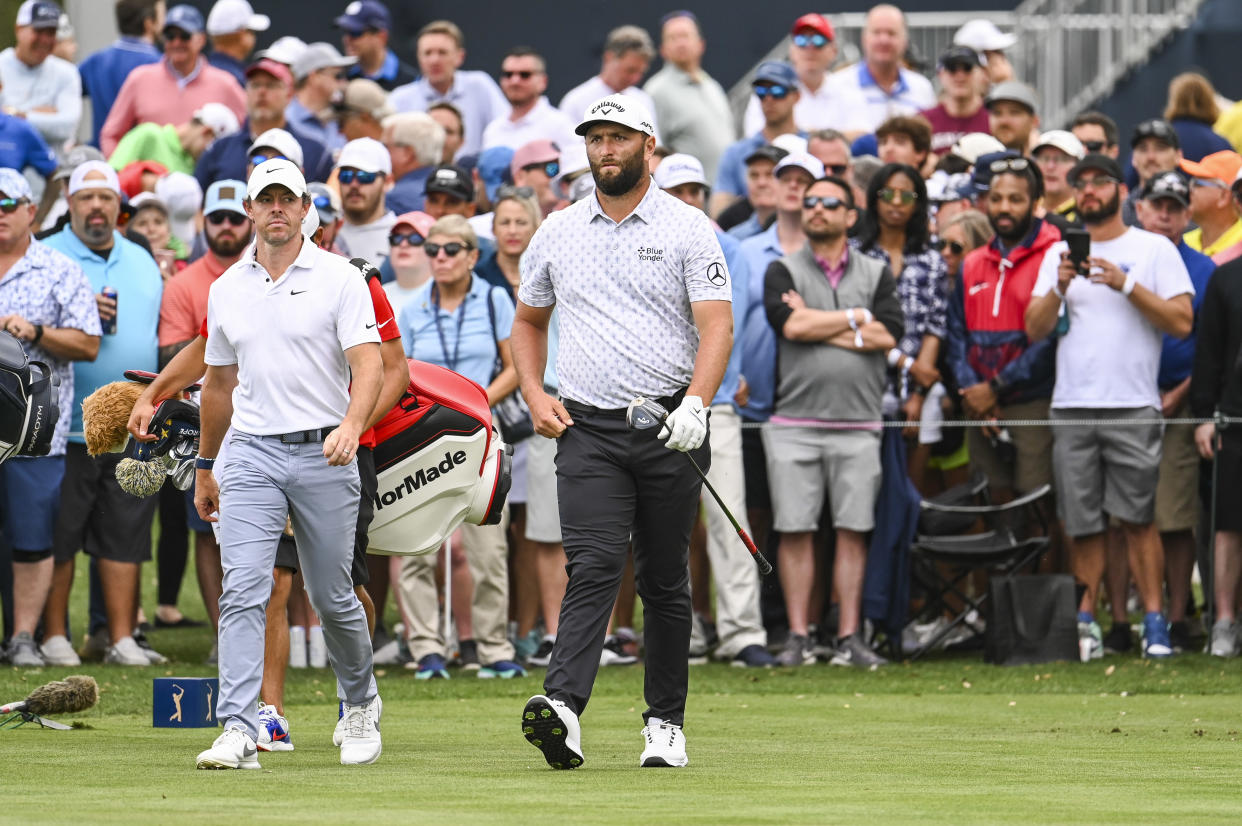 PONTE VEDRA BEACH, FLORIDA - MARCH 9:  Jon Rahm of Spain and Rory McIlroy of Northern Ireland walk off the ninth hole tee during the first round of THE PLAYERS Championship on the Stadium Course at TPC Sawgrass on March 9, 2023 in Ponte Vedra Beach, Florida. (Photo by Keyur Khamar/PGA TOUR via Getty Images)