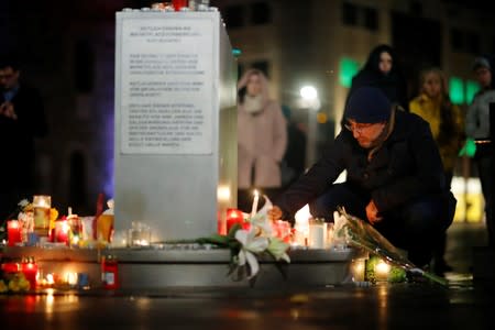 A person puts a candle at central market square in Halle