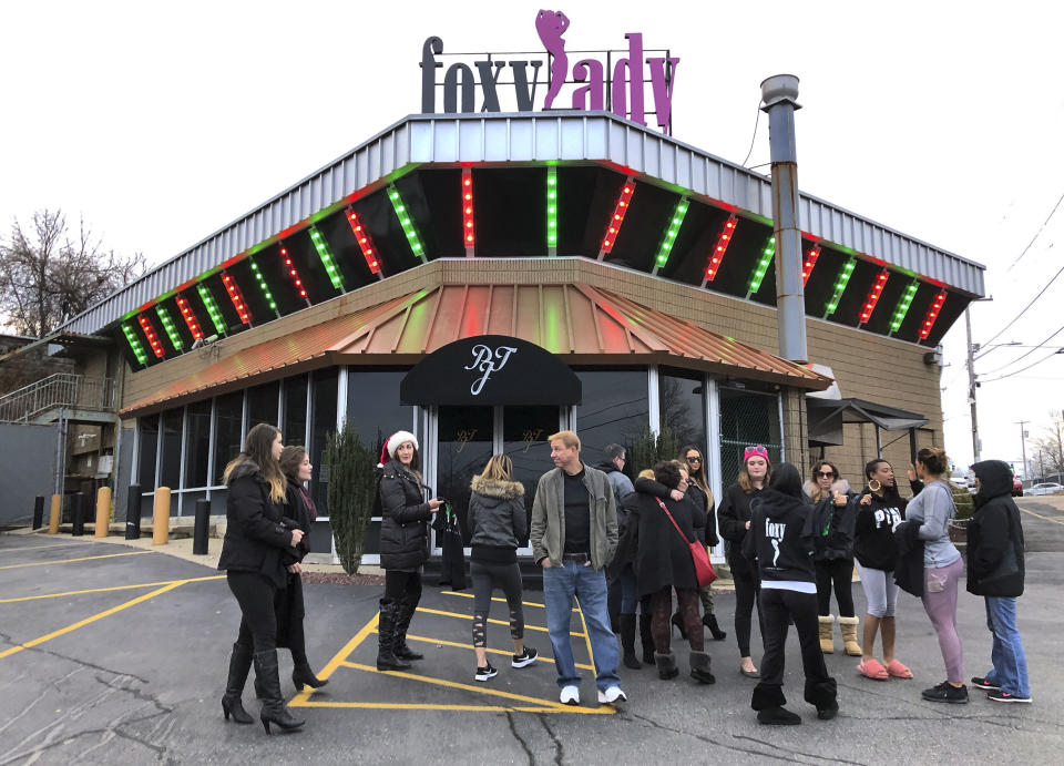 Former workers gather outside the Foxy Lady strip club, Thursday, Dec. 20, 2018, in Providence, R.I. The city ordered the club to close on Wednesday. A city board voted to revoke its licenses after police charged three dancers with prostitution the previous week. (AP Photo/Michelle R. Smith)