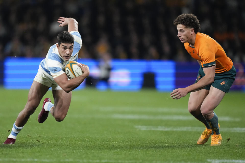 Argentina's Santiago Carreras, left, makes a run past Australia's Mark Nawaqanitawase during the Rugby Championship test match between Australia and Argentina in Sydney, Australia, Saturday, July 15, 2023. (AP Photo/Rick Rycroft)