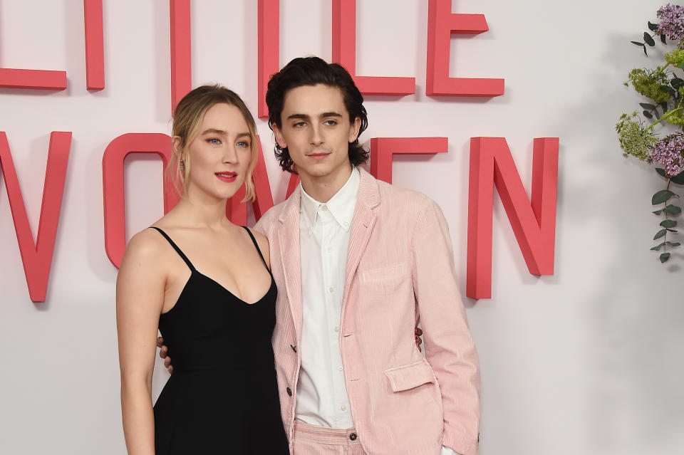 Saiorse and Timothée at the "Little Women" premiere, she in a black dress and he in a pink suit