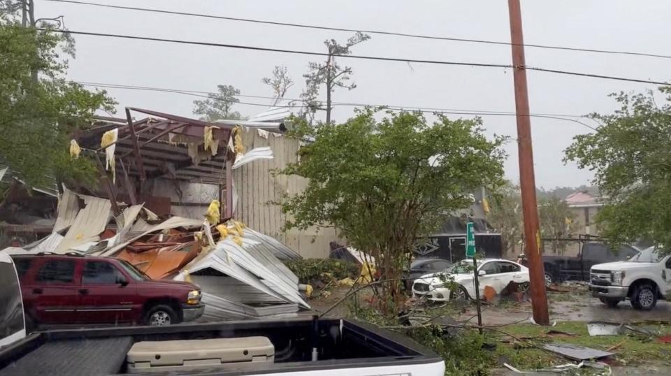 PHOTO: Vehicles stand near a destroyed structure on a road after a tornado touched down in Slidell, La., April 10, 2024 in this screen grab obtained from social media video.  (St. Tammany Parish/via Reuters)