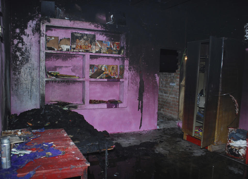 In this Thursday, Feb. 20, 2014, the burnt house of Bunty Sharma, 32, an auto rickshaw driver, is seen, in Agra, India. Bunty fatally stabbed his American wife Erin W. Willinger before killing himself in Agra, the city that is home to the Taj Mahal and where the couple married in October, police said Saturday. Willinger's body was found with multiple stab wounds late Thursday night in a deserted part of the city, said Agra police chief Shalabh Mathur. Her husband Bunty Sharma committed suicide by igniting cooking gas and causing a massive explosion in his home, Mathur said. (AP Photo)