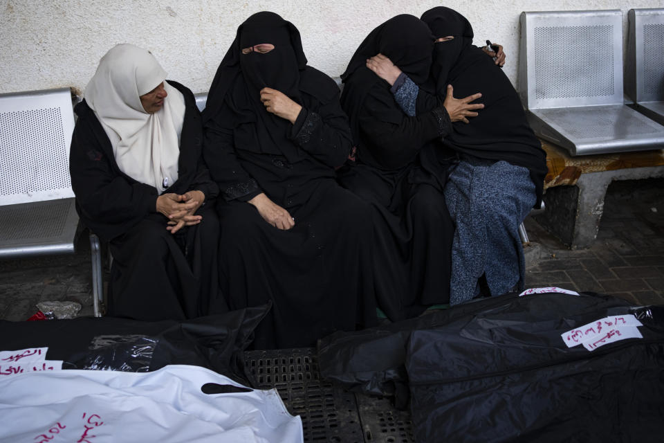 Palestinians mourn relatives killed in the Israeli bombardment of the Gaza Strip at a hospital in Rafah, Friday, Feb. 9, 2024. (AP Photo/Fatima Shbair)