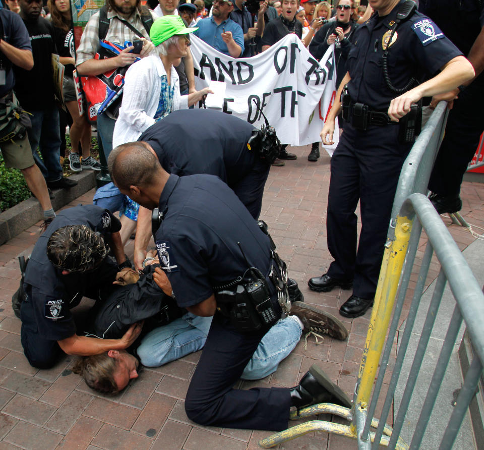 Charlotte-Mecklenburg police quickly arrest a man who tried to enter the Bank of America's shareholder meeting during a protest, Wednesday May 9, 2012, in Charlotte, N.C. Hundreds of people gathered on the streets as dozens of police officers worked to contain the protest. (AP Photo/Bob Leverone)